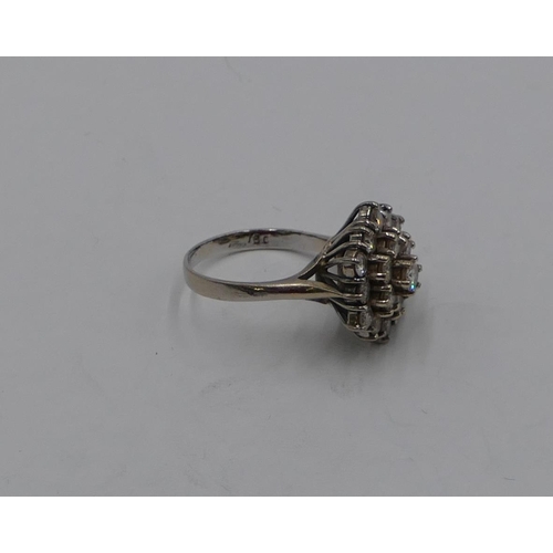 392 - An 18ct white gold diamond waterfall cluster ring set with 19 diamonds, centre diamond approx. 0.20c... 