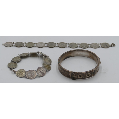 397 - A Birmingham silver hinged bangle in form of a buckle and 2 coin bracelets. (3)