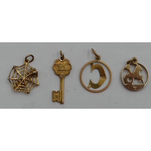 402 - 3 9ct gold charms and another gold charm in form of a spider's web, 5.7 grams. (4)