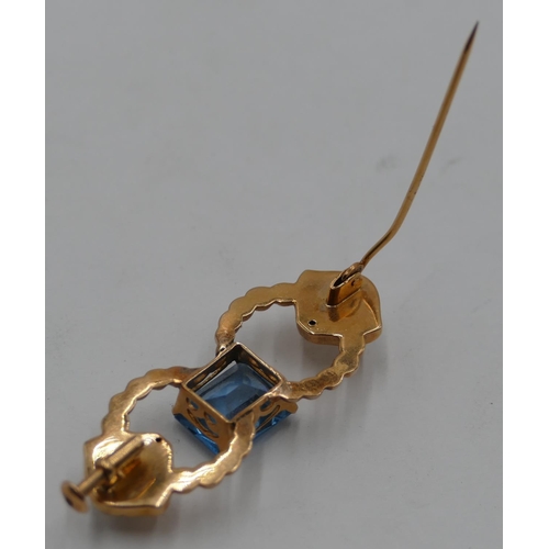 406 - A gold brooch set with centre aquamarine style stone, 3.7cm long, 4.2 grams gross.