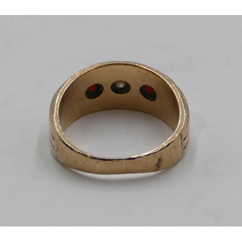 409 - A gold ring set with clear stone and flanked by 2 red stones, size O/P, 6.8 grams gross.