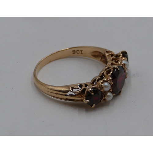 412 - A 9ct gold ladies' ring set with 3 garnets interspersed by 4 small half pearls, size S, 3.9 grams gr... 