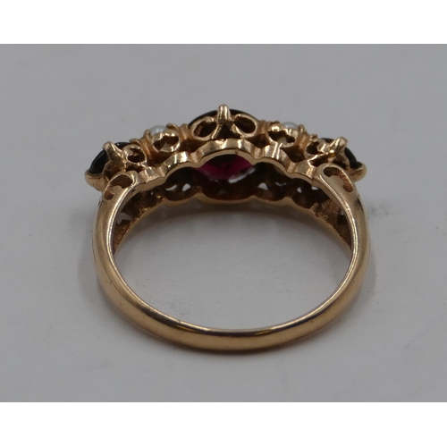 412 - A 9ct gold ladies' ring set with 3 garnets interspersed by 4 small half pearls, size S, 3.9 grams gr... 