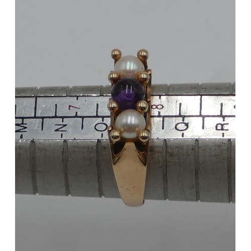 413 - A 9ct gold ladies' ring set with centre purple stone and flanked by 2 pearls, size P, 3.7 grams gros... 