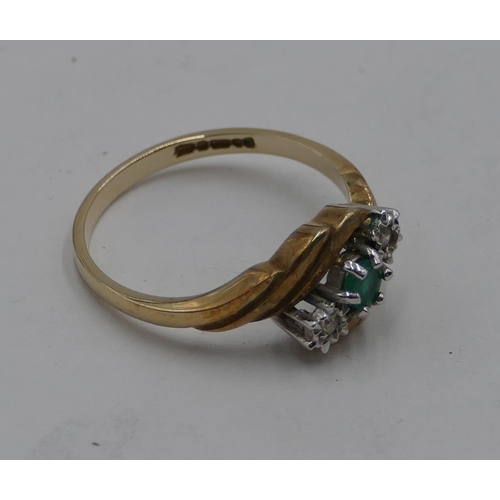 417 - A 9ct gold ladies' twist ring set with centre small emerald and flanked by 2 small diamonds, size P,... 