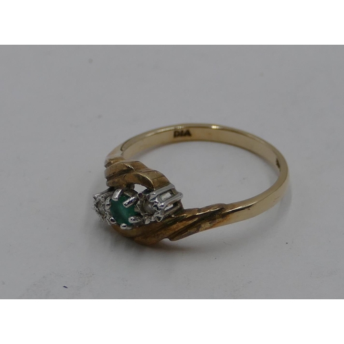 417 - A 9ct gold ladies' twist ring set with centre small emerald and flanked by 2 small diamonds, size P,... 