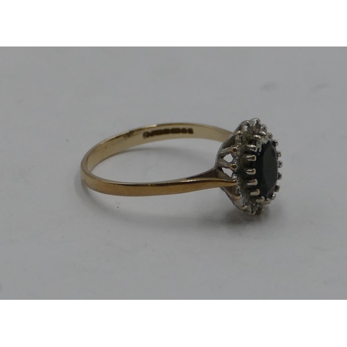 418 - A 9ct gold oval cluster ring set with centre sapphire and surrounded by small diamonds chips, size Q... 