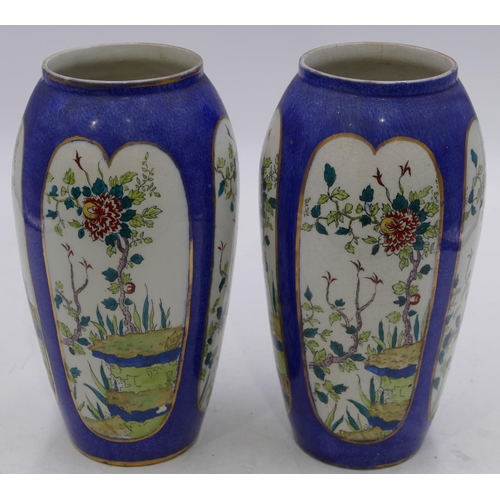 42 - A pair of round bulbous shaped vases on white and blue ground with panels of branch, floral and leaf... 