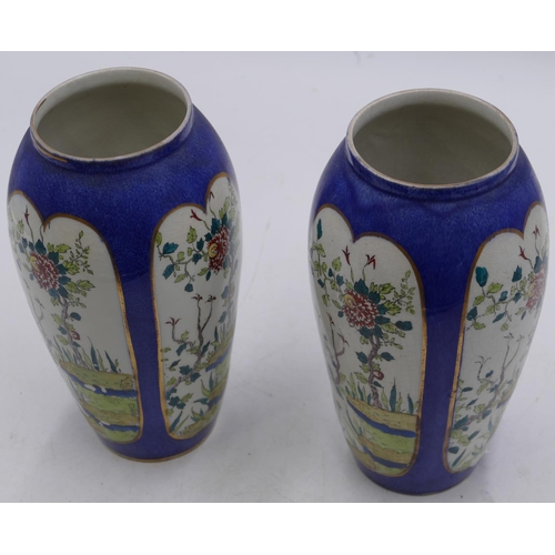 42 - A pair of round bulbous shaped vases on white and blue ground with panels of branch, floral and leaf... 