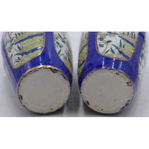 42 - A pair of round bulbous shaped vases on white and blue ground with panels of branch, floral and leaf... 