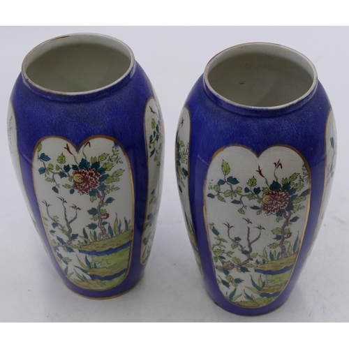 42 - A pair of round bulbous shaped vases on white and blue ground with panels of branch, floral and leaf... 