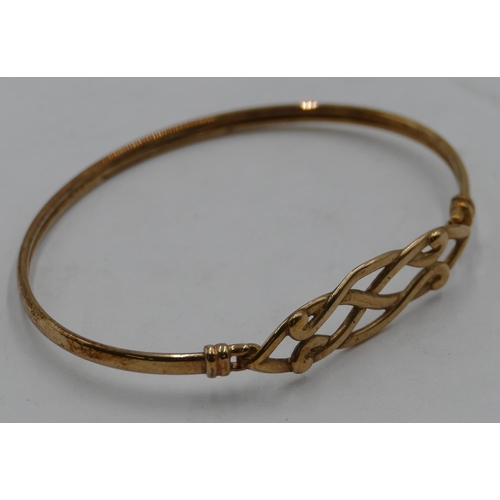 429 - A gold bangle with pierced top, 4.9 grams.