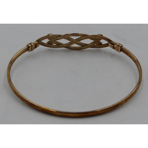 429 - A gold bangle with pierced top, 4.9 grams.