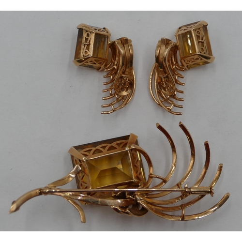 431 - A gold garniture of brooch and pair of earrings, all mounted with yellow quartz with sprays of leaf ... 