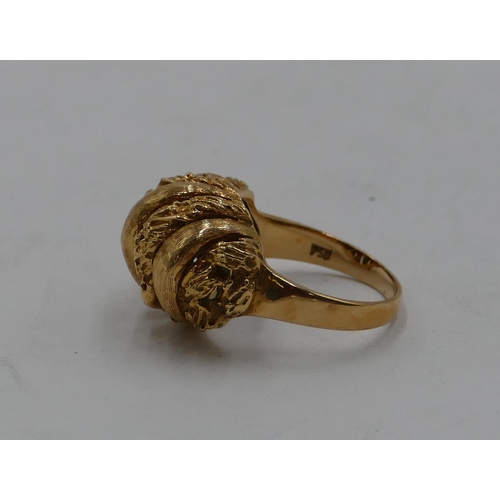 436 - An 18ct gold ring with pierced and embossed top, size L/M, 6.3 grams.