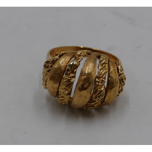 436 - An 18ct gold ring with pierced and embossed top, size L/M, 6.3 grams.