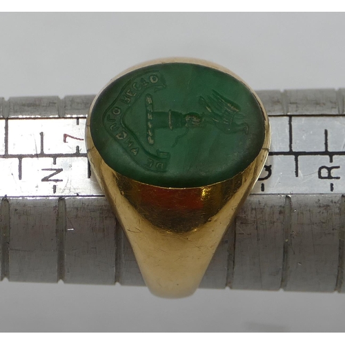 440 - An 18ct gold oval ring set with green intaglio depicting crest, size P, 13.4 grams.