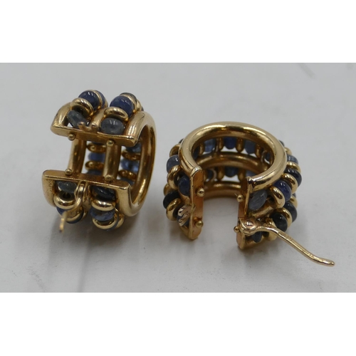 443 - A pair of 14ct gold circular earrings inset with 2 rows of blue stones, 9 grams gross.