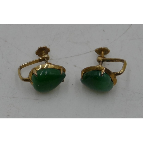 455 - A pair of 14ct gold screw earrings set with heart shaped jade panels.