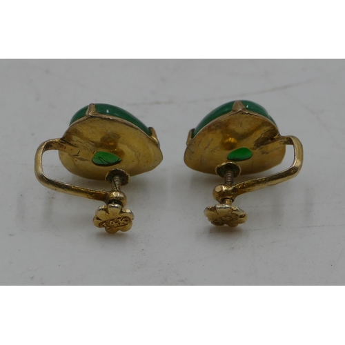 455 - A pair of 14ct gold screw earrings set with heart shaped jade panels.