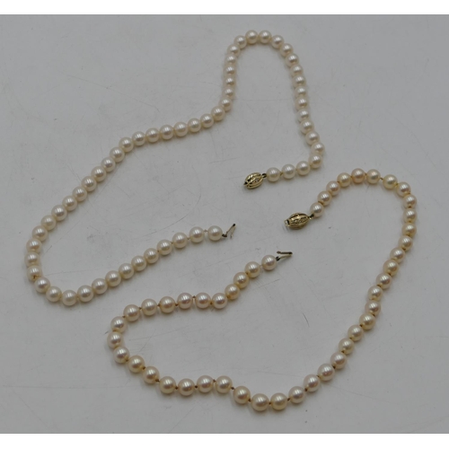 497 - 2 cultured pearl necklaces with matching 9ct gold clasps, 39 and 43cm long.