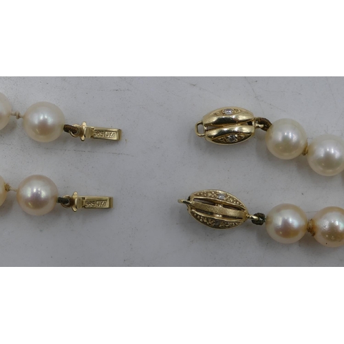 497 - 2 cultured pearl necklaces with matching 9ct gold clasps, 39 and 43cm long.