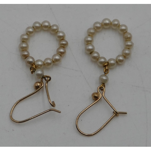 501 - A pair of 9ct gold circular drop earrings mounted with small pearls.