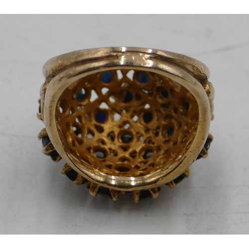 507 - A 9ct gold large cluster ring with pierced decoration and mounted with various sapphires, size L/M, ... 