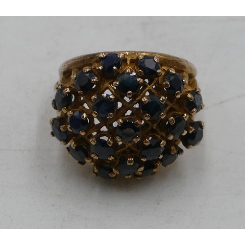 507 - A 9ct gold large cluster ring with pierced decoration and mounted with various sapphires, size L/M, ... 