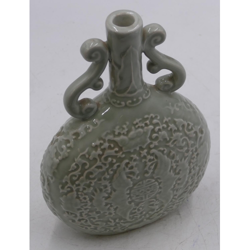 51 - An Oriental bulbous thin necked two-handled bottle vase on pale green ground with raised bat and scr... 