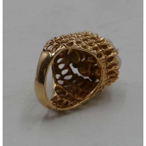 511 - A 14ct gold cluster ring with allover pierced decoration, mounted with 7 cultured pearls and intersp... 