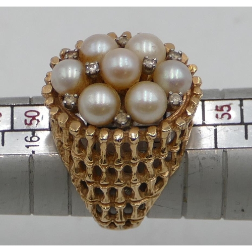 511 - A 14ct gold cluster ring with allover pierced decoration, mounted with 7 cultured pearls and intersp... 