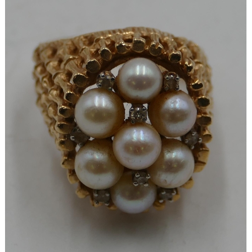 511 - A 14ct gold cluster ring with allover pierced decoration, mounted with 7 cultured pearls and intersp... 