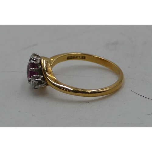 513 - An 18ct gold twist ring with centre ruby flanked by 2 small diamonds, size L. 2.9 grams.