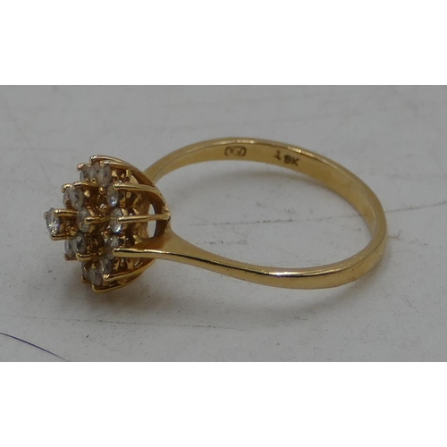 515 - An 18ct gold cluster ring set with 19 diamonds, size M, 2.3 grams.