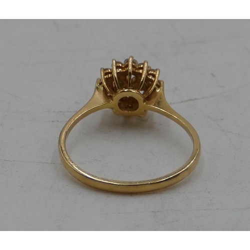 515 - An 18ct gold cluster ring set with 19 diamonds, size M, 2.3 grams.