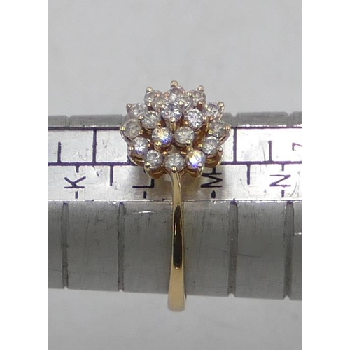 515 - An 18ct gold cluster ring set with 19 diamonds, size M, 2.3 grams.