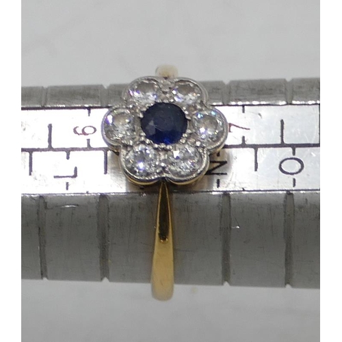 517 - An 18ct gold ladies' circular cluster ring with centre sapphire and flanked by 6 diamonds, size M, 2... 