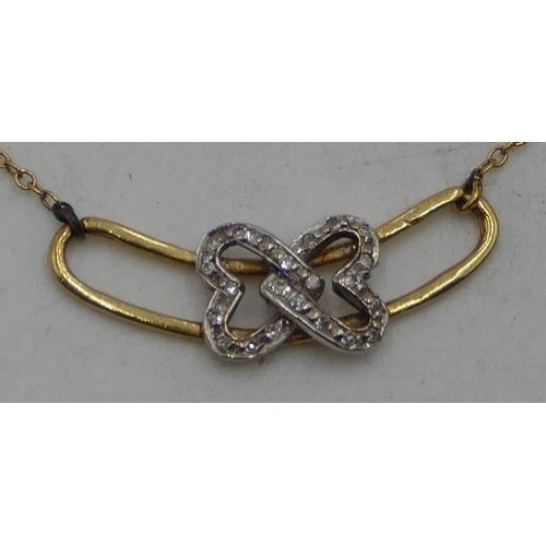 518 - An 18ct gold drop pendant with entwined parts, inset with small diamonds, with chain, 38cm long, 3.2... 