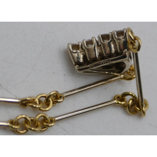 522 - An 18ct gold triangular shaped pendant inset with 10 diamonds on 18ct gold linked and bar chain, 40c... 