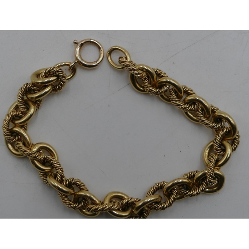 523 - An 18ct gold engraved and plain linked bracelet with later 14ct gold clip, 20cm long, 41.4 grams gro... 