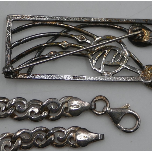 525 - A modern Carrick brooch in the style of Rennie Mackintosh (boxed) and a silver flat chain. (2)