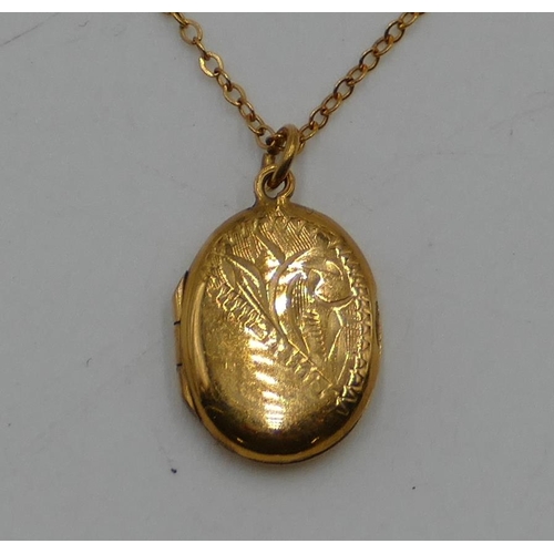 526 - A 9ct gold oval locket with engraved hinged front and gold chain, 2.1g gross.