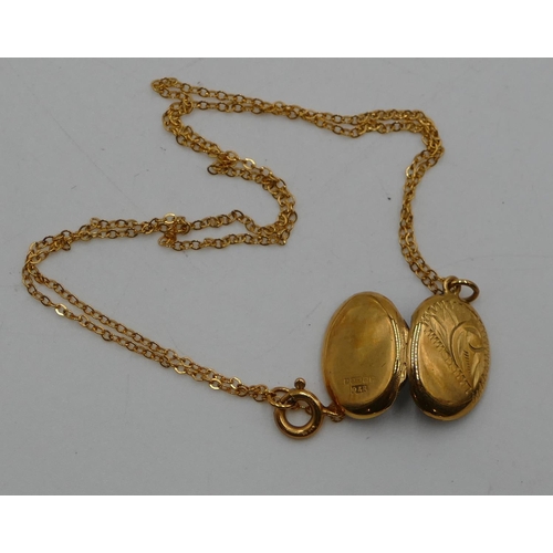 526 - A 9ct gold oval locket with engraved hinged front and gold chain, 2.1g gross.