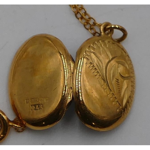 526 - A 9ct gold oval locket with engraved hinged front and gold chain, 2.1g gross.