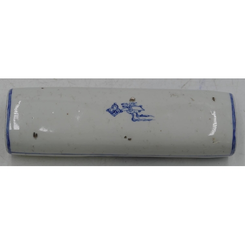 54 - An Oriental oblong blue and white scroll weight with figure decoration, 16cm long.