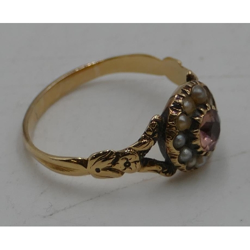 540 - A Victorian gold ladies' cluster ring set with centre pink stone surrounded by half pearls (2 pearls... 