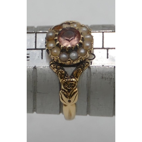 540 - A Victorian gold ladies' cluster ring set with centre pink stone surrounded by half pearls (2 pearls... 