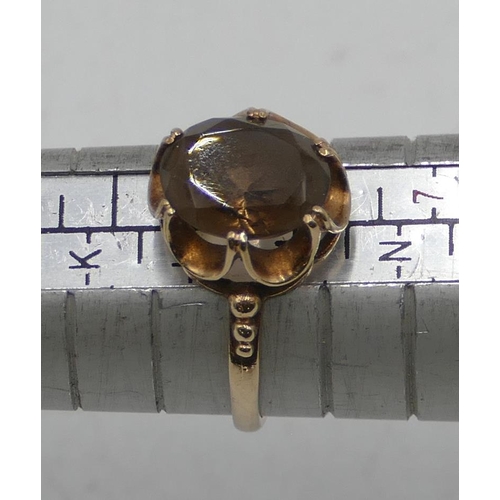 550 - A 9ct gold ladies' smoky quartz ring with pierced rim, size L/M, 2.1 grams gross.