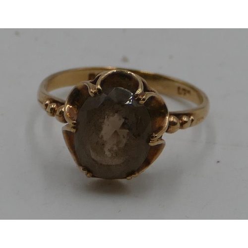 550 - A 9ct gold ladies' smoky quartz ring with pierced rim, size L/M, 2.1 grams gross.